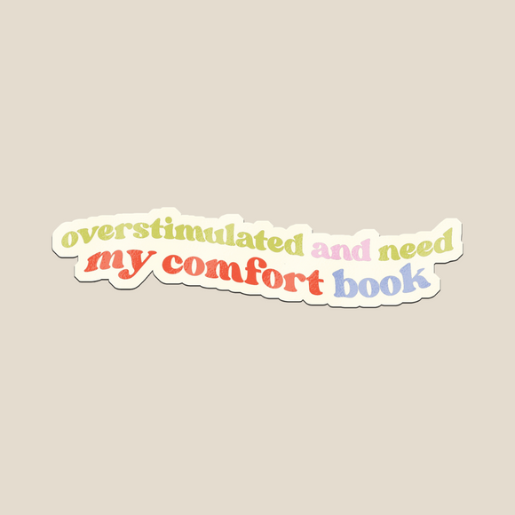 This Overstimulated and Need My Comfort Book sticker and  features soft pastel rainbow text with a retro vibe