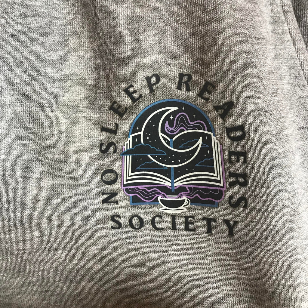 no sleep reader society iron on patch for clothing. Featured: grey sweatpants with patch