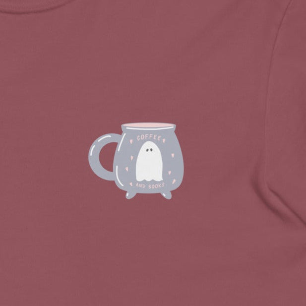 Maroon t-shirt with a design featuring a ghost inside of a coffee cu on the chest against a white background