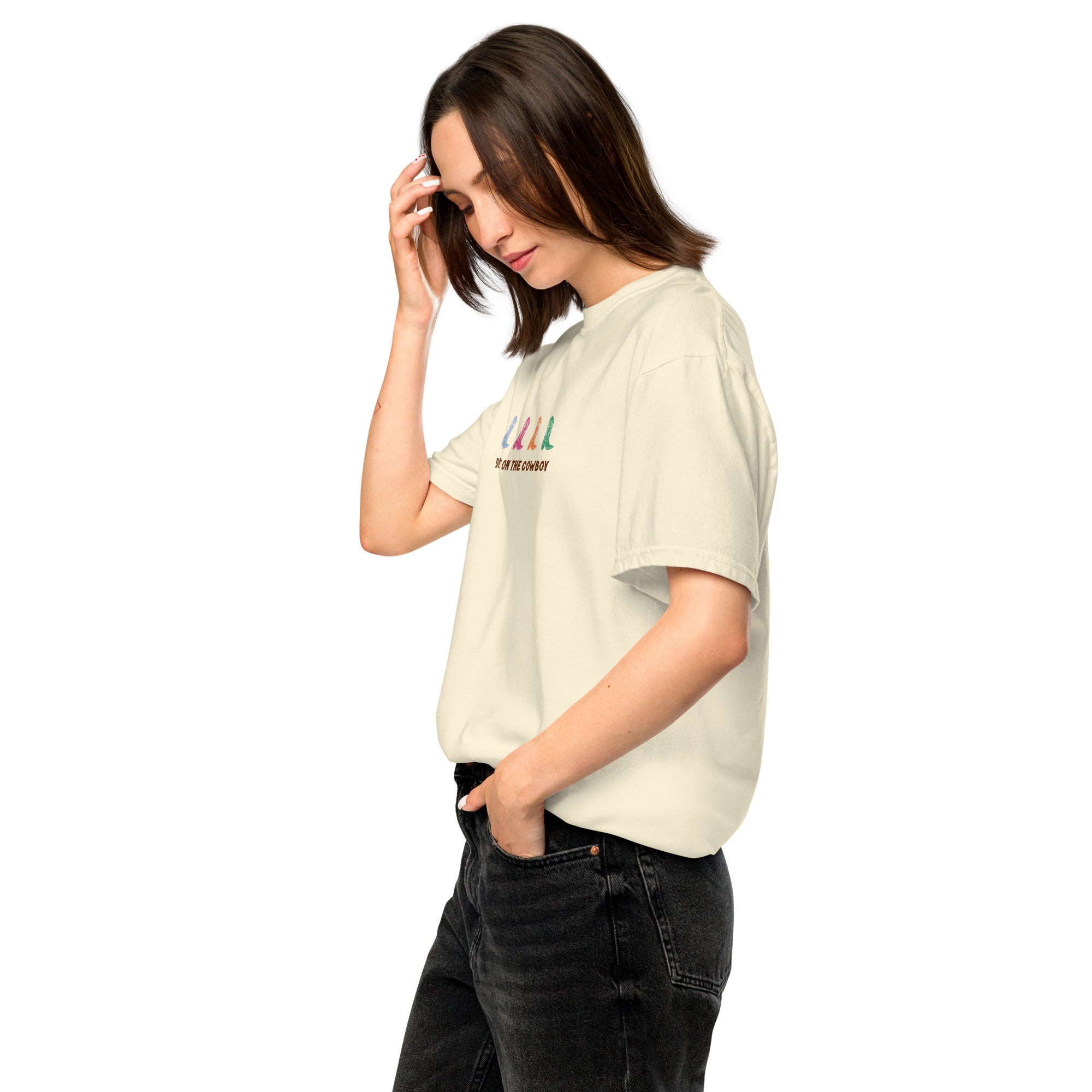woman wearing beige t-shirt with colorful cowboy boots and text that reads "dibs on the cowboy". Shown on a white background